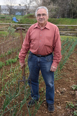 portrait of a retired man in his vegetable garden