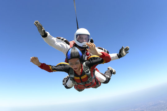 Tandem jump. The girl with the instructor in freefall.