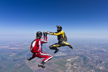 Two parachutists girls in free fall.