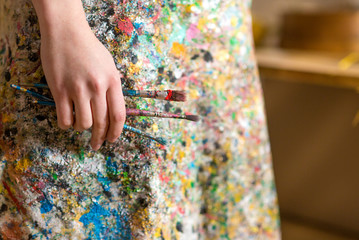 Closeup of female artist hand holding paintbrush
- 103906740