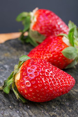 large strawberries dark background. choicest berries. color image with space for text. side and top view