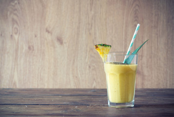 pineapple smoothie with chia seed on wooden table.