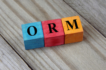 ORM (Online Reputation Management) acronym on colorful wooden cu