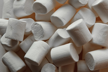 beautiful little marshmallows scattered on a light background