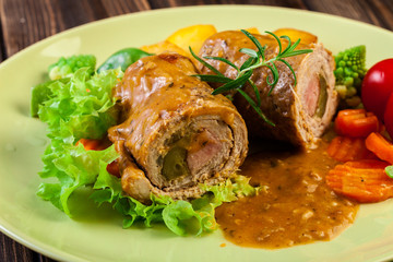 Pork rolls with prepared potatoes and vegetables