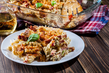 Portion of fusilli pasta casseroles, sausages and zucchini