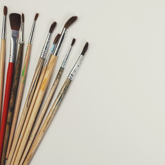  brushes for painting  and blank white paper sheet 