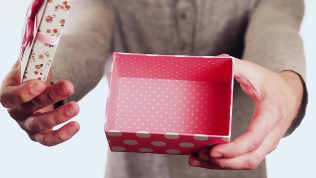 Handsome guy gives a gift in the box for his birthday. The guy opens the box, and the box is empty. Gift no.