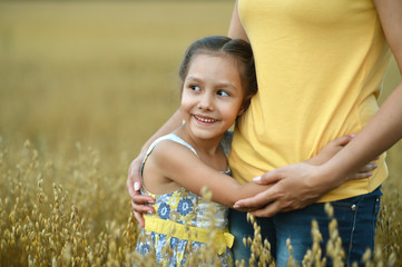 mother and daughter at  wheat field