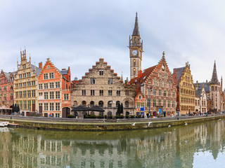 Fototapeta premium Picturesque panorama with medieval building and Clock Tower on the quay Graslei at Ghent town, Belgium