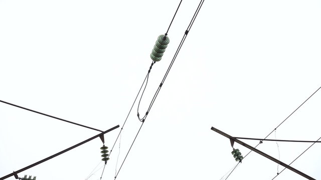 Closeup isolators, high-voltage network on the sky background. 4K