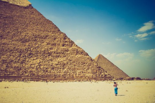 View of the Giza Pyramids and photographer tourist near them. Egypt. Cairo.