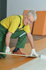 Senior man  repairing in the room