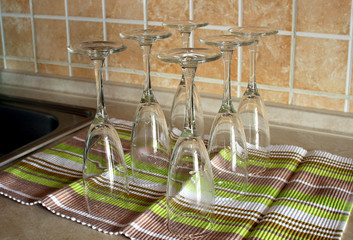 Empty glasses standing upside down on a towel..