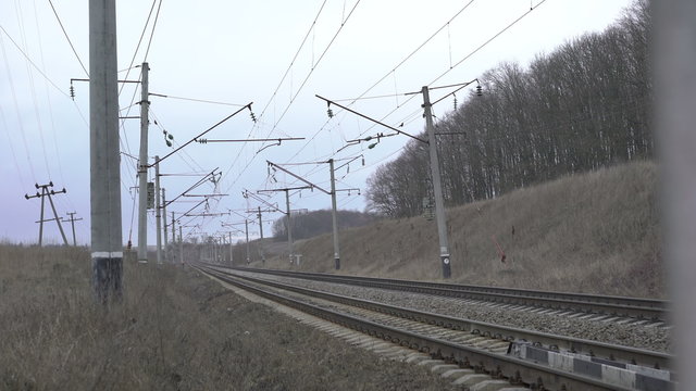 Railway track, isolators, grey grass in the Ukrainian fields. 4K