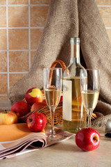 Glasses of wine and a basket of apples..