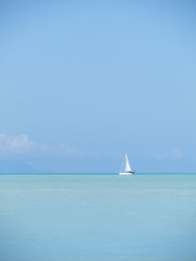 Obraz premium Sailboat cruising beautiful turquoise waters of the Caribbean