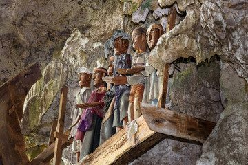 Wooden statues of Tau Tau in TampangAllo burial cave at Tana Toraja. Indonesia © Elena Odareeva