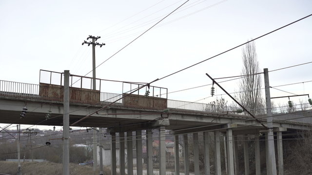 High-voltage network, isolators, bridge, road in the Ukrainian village. 4K