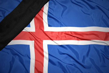 Fototapeta premium national flag of iceland with black mourning ribbon