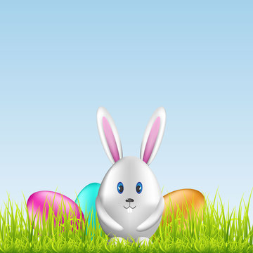 Easter bunny and colorful eggs on spring medow