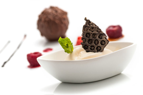 chocolate ball with ice cream and fruit on white plate, sweet dessert with chocolate, product photography for patisserie or restaurant