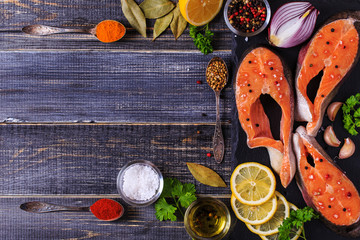 Fresh raw salmon steaks with ingredients.