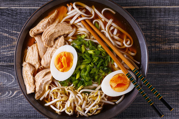 Japanese ramen soup with chicken, egg, chives and sprout.
