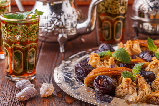 Moroccan mint tea in the traditional glasses with sweets.