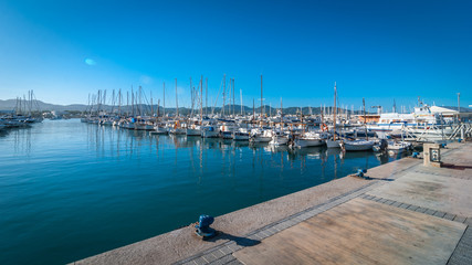Sail boats idle in Ibiza marina harbor in the morning of a warm sunny day in St Antoni de Portmany Balearic Islands, Spain.   - 103915792