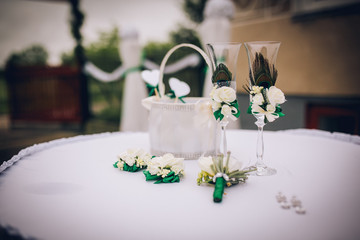 Wedding accessories decorated with various flowers and feathers Peacock