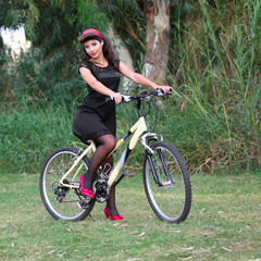 Fototapeta premium Pin-up girl poising on a bike