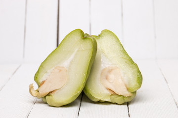 Chayote fruit on white wood background