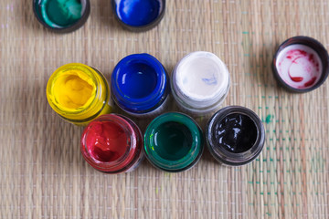 Top view of opened bottles of poster paint