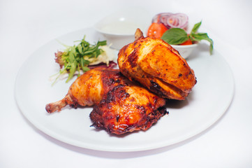 Fried chicken legs with salad from vegetables and greens with white sauce