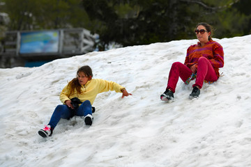 Fototapeta na wymiar girls on a snowy hill