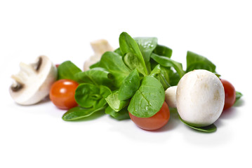 fresh garden salad with white mushrooms, cherry tomatoes and corn salad, isolated on white background.