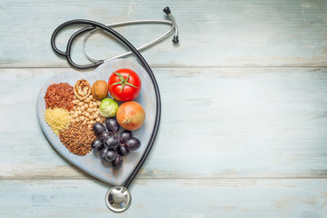 Healthy lifestyle and healthcare concept with food, heart and stethoscop
