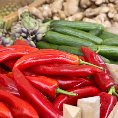 Fruit market with various fruits and vegetables. Fresh vegetables and fruits at a market stall. Colorful vegetable and fruits in a row with copy space. Pointed pepper in the foreground.