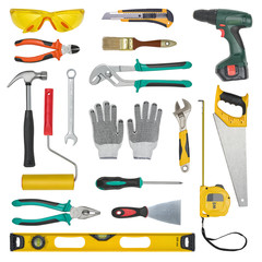 Set of construction tools isolated on a white background. Level, saw, glasses, tape measure, wrench, spanner, paint roll, hammer, cutter, pliers.