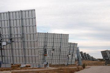 Field of photovoltaic solar panels gathering energy.