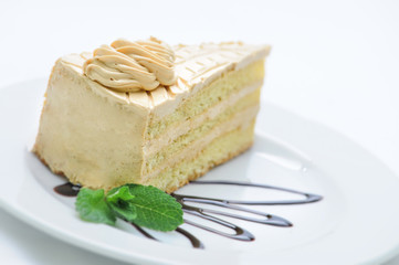 cream cake with nuts and topping on white plate, sweet dessert, product photography for patisserie or shop