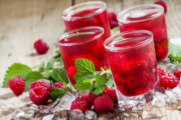Refreshing raspberry drink with berries, ice and mint, selective
