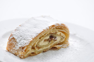 curd strudel with powder sugar on white plate, product photography for patisserie or bakery