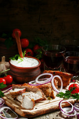 Pieces of meat barbecue on a wooden cutting board with vegetable