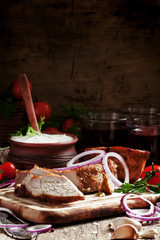 Pieces of meat barbecue on a wooden cutting board with vegetable