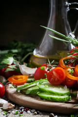 Cut fresh vegetables, spices and olive oil for a spring salad, h