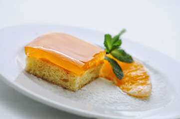fruits cake with mint leaf and orange on white plate, sweet dessert or breakfast, birthday cake, patisserie, photography for shop