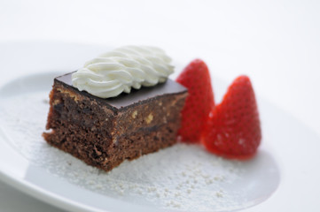 cream cake with whipped cream and strawberries on white plate, product photography for patisserie or shop