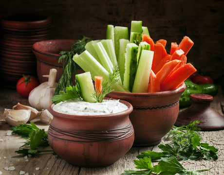 Fresh sticks carrots, celery, cucumber and white sauce with herb